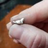 Tiny handmade silver (PMC) bird... made a few to top a couple of bullet pendants (See next pic), custom request. 